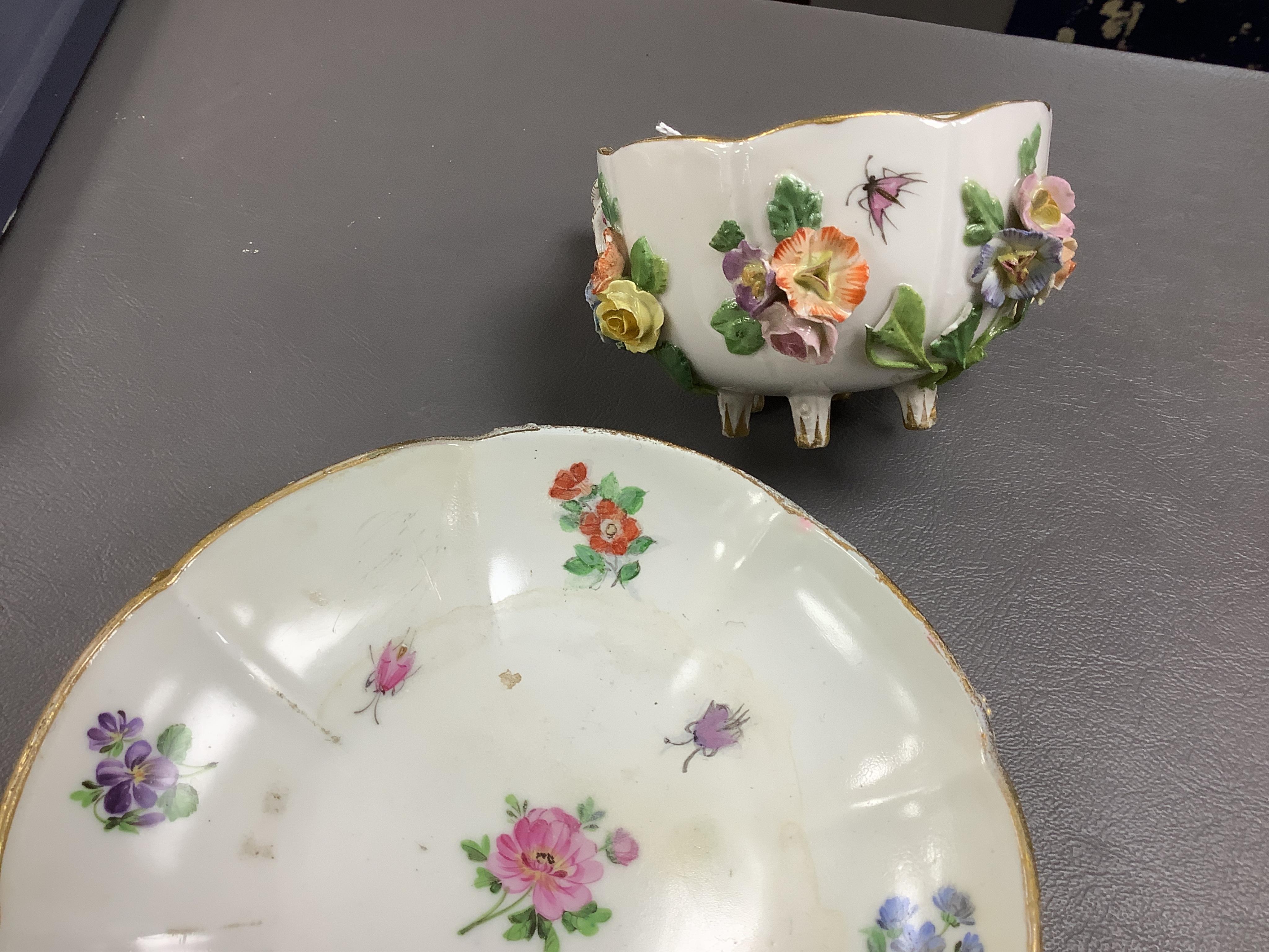 A 19th century Meissen floral encrusted cup and saucer, 14cm diameter